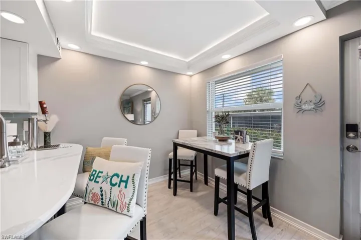 Dining area with recessed lighting, large window, and convenient access to the kitchen and breakfast bar.