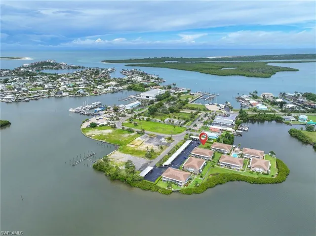 Aerial view of the Naples Florida waterfront community surrounded by canals, mangroves, and nearby Gulf waters.