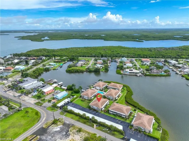 Aerial view showcasing the Naples Florida waterfront community with boating access and nearby mangrove preserve.