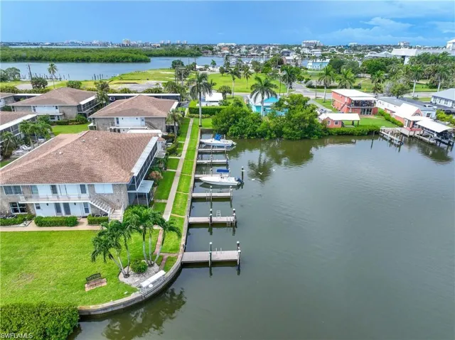 Aerial view of the waterfront community featuring boat docks, direct water access, and the coastal setting of Isles of Capri.