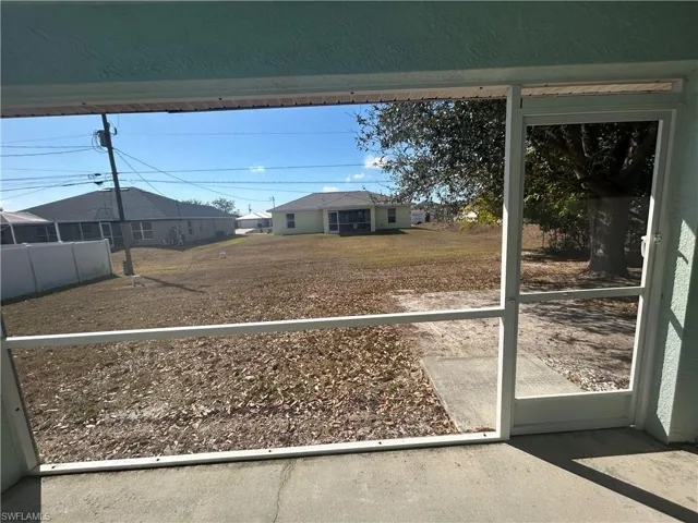 View of yard with a sunroom and a residential view