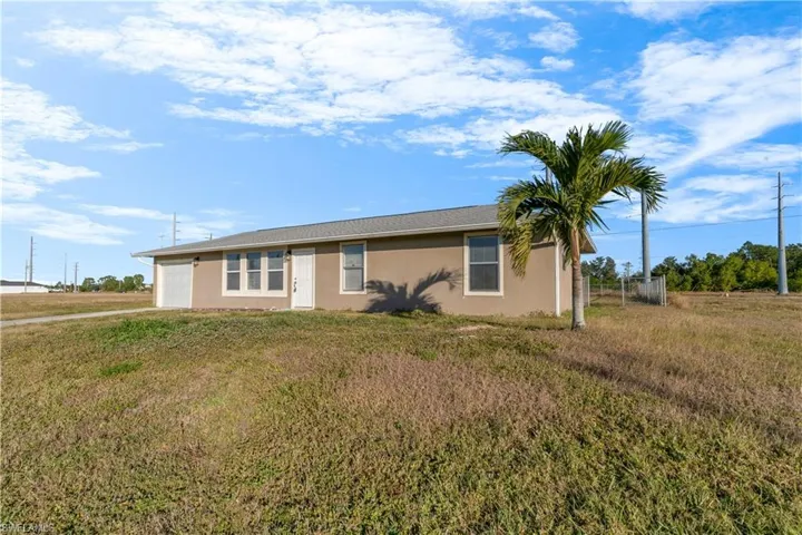 Ranch-style home with a front lawn