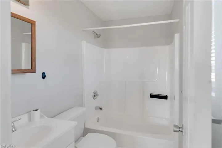 Full bathroom with shower / bathing tub combination, vanity, and toilet