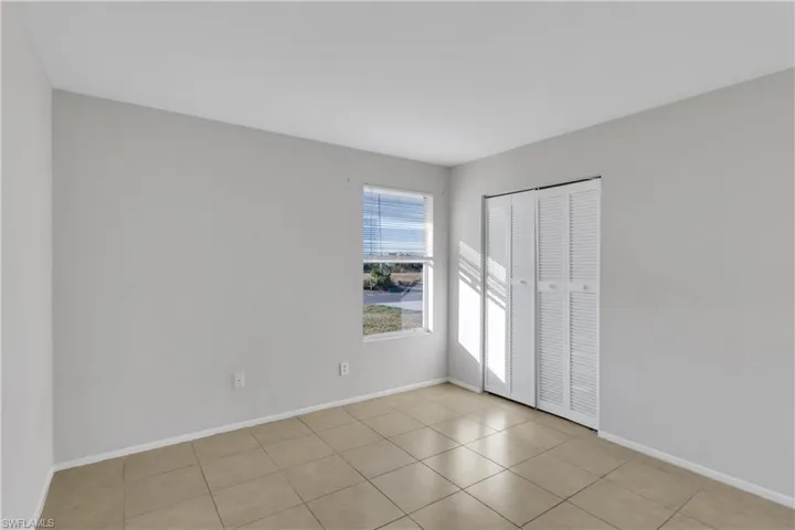 Empty room with light tile patterned floors