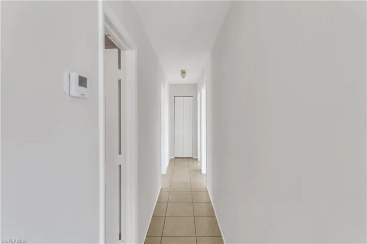 Hallway featuring light tile patterned flooring