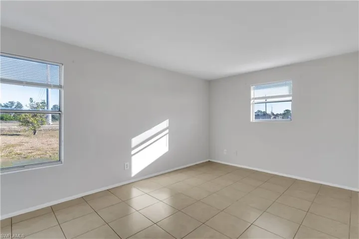 Empty room with light tile patterned flooring