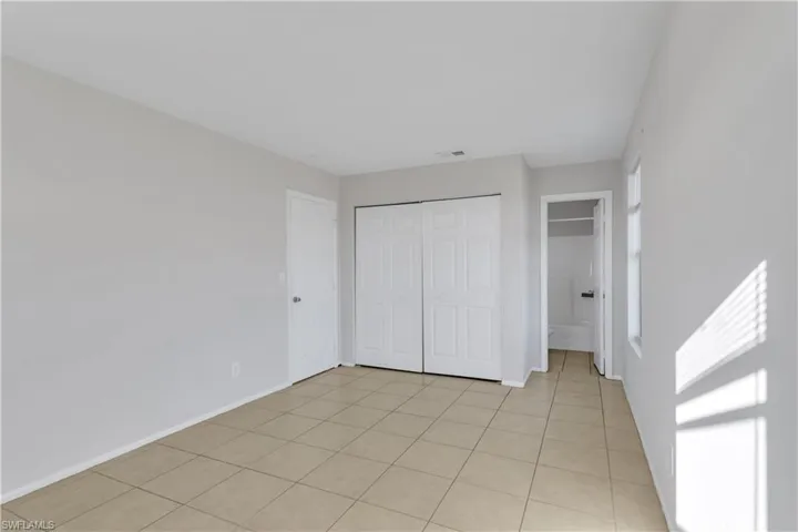 Unfurnished bedroom featuring light tile patterned floors