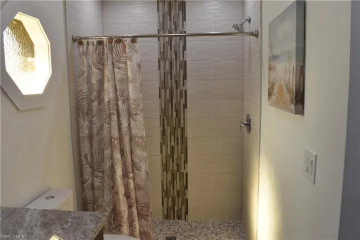 Bathroom with a stall shower and vanity