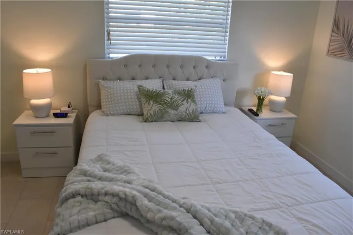 Bedroom featuring baseboards and light tile patterned flooring