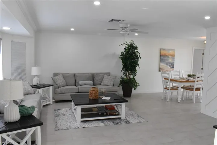 Living area with recessed lighting, crown molding, and ceiling fan