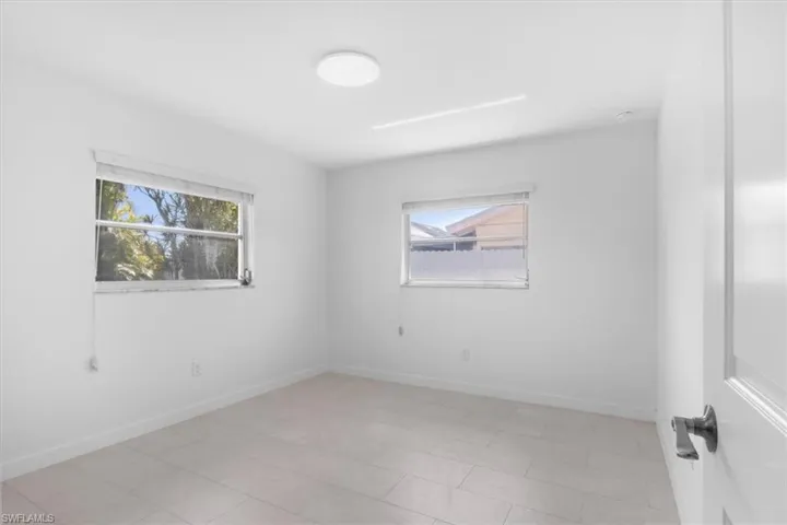 Spare room featuring plenty of natural light and light tile patterned floors