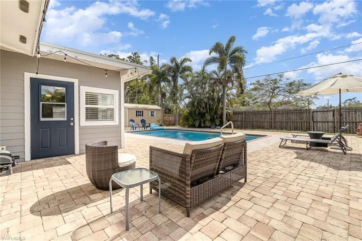 View of patio / terrace featuring a storage shed and a fenced in pool