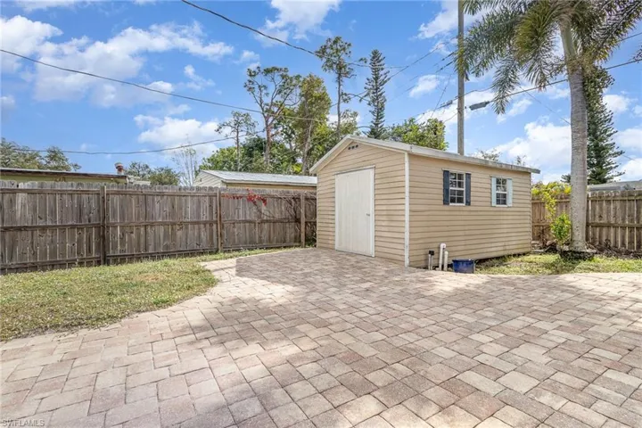 View of patio with a shed