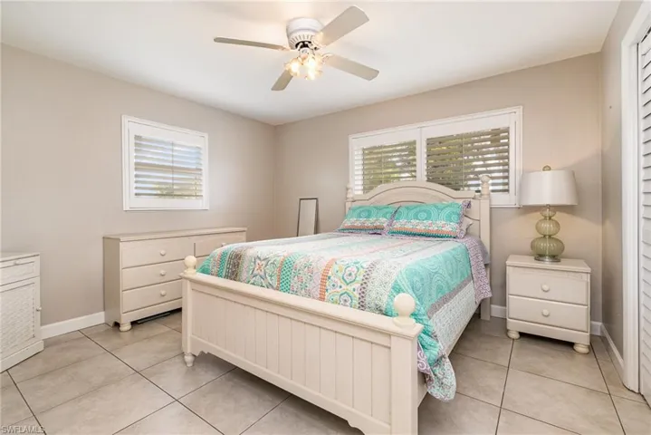 Tiled bedroom with ceiling fan