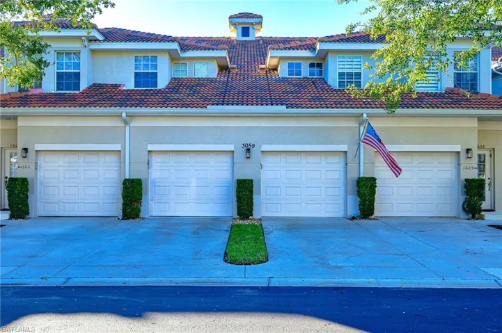View of front of house with stucco siding, a tiled roof, and concrete driveway