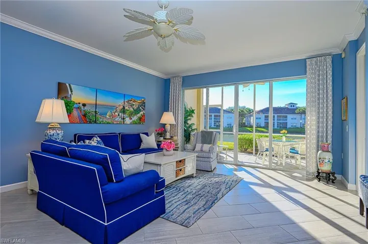 Spacious family room with crown molding and ornate ceiling fan