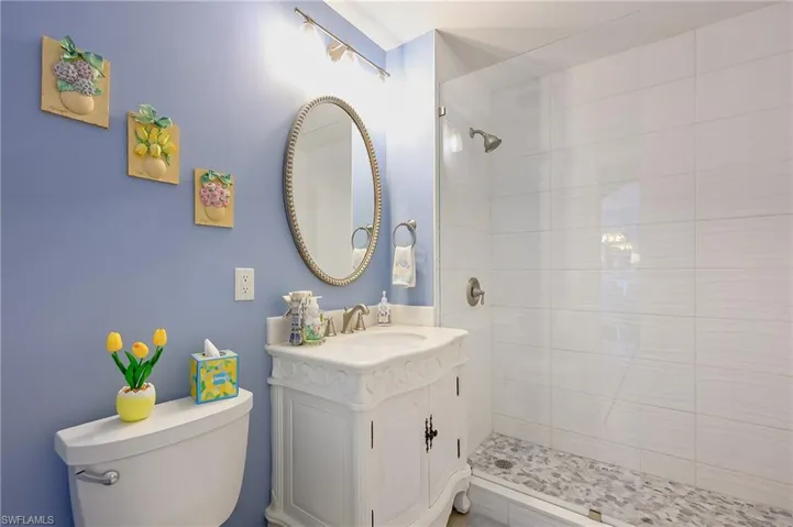 Full bath featuring vanity and a shower stall