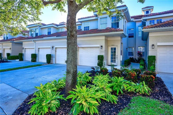 Mediterranean / spanish home with a tile roof, stucco siding, concrete driveway, and a garage