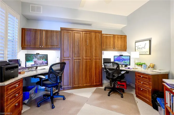 Bedroom/den area with built in desks and ceiling fan