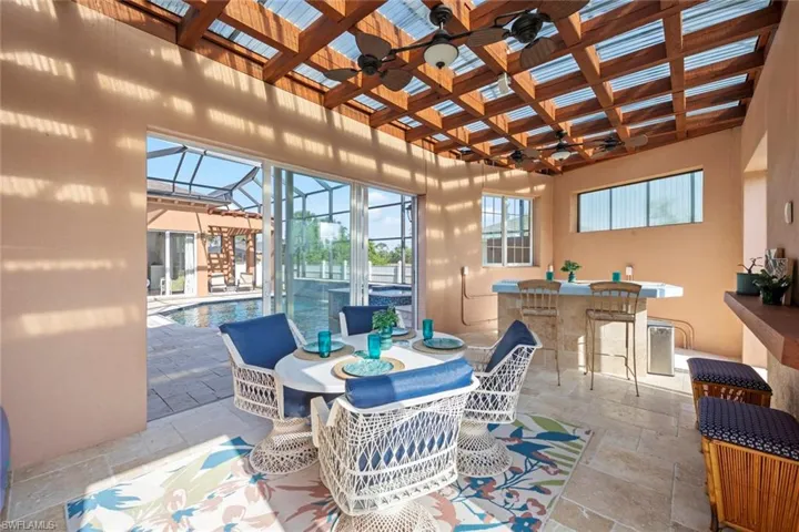 View of cabana sun room featuring a glass enclosure, entertaining area