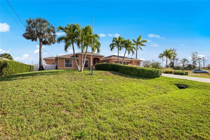 Ranch-style home featuring a front lawn and stucco
