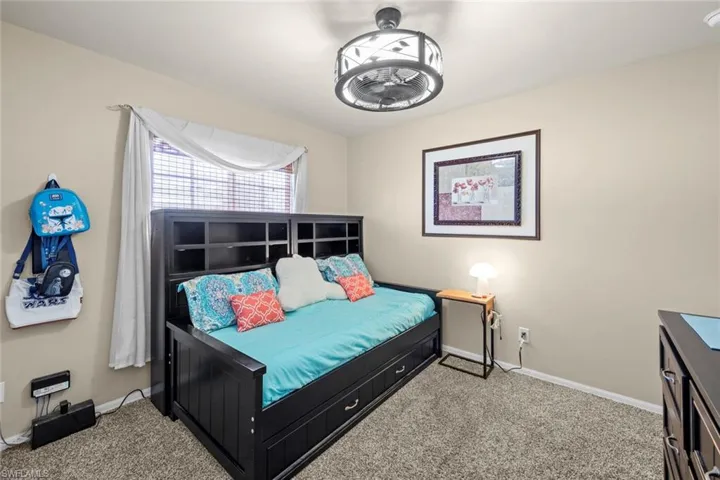 Carpeted bedroom with baseboards