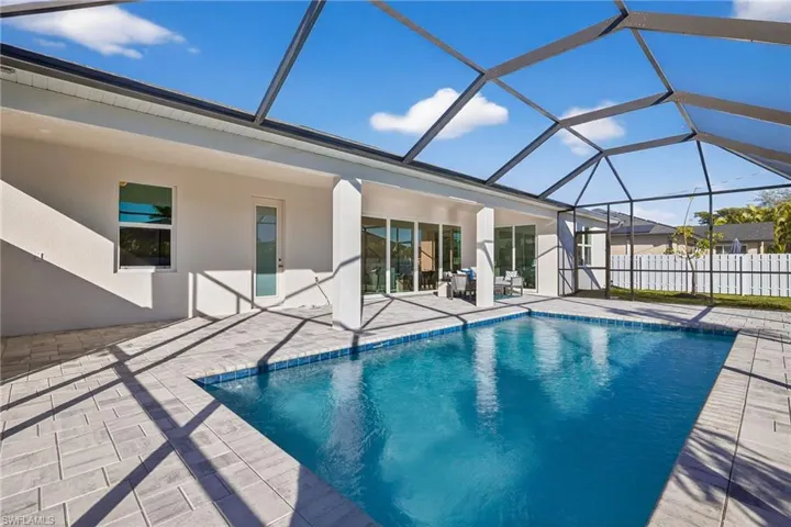 View of pool with a sunroom, a lanai, and a patio area