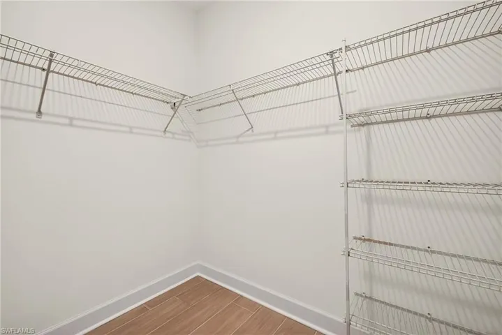 Walk in closet featuring wood tiled floors