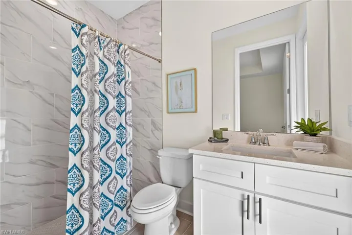 Bathroom featuring a stall shower and vanity