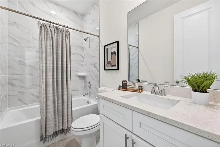 Bathroom with shower / bath combo and vanity