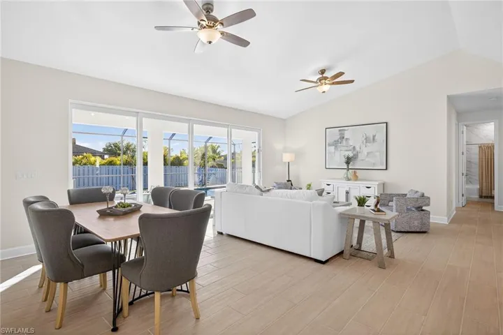 Dining area with wood tiled floors, vaulted ceiling, and ceiling fan