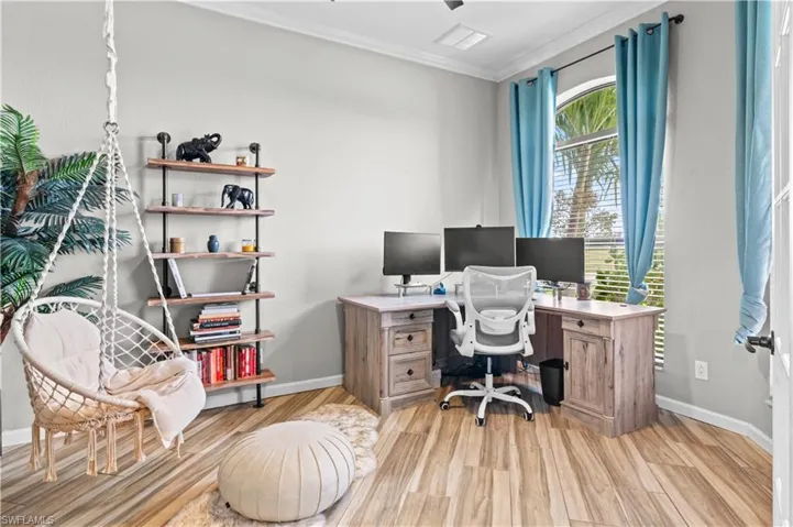 Office space featuring crown molding and light wood-style flooring