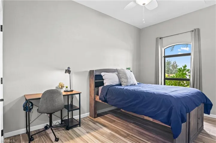 Bedroom with ceiling fan and wood finished floors