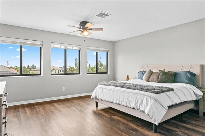Bedroom featuring dark wood finished floors and a ceiling fan