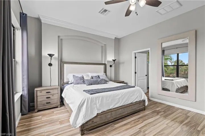 Bedroom featuring wood tiled floors and ceiling fan