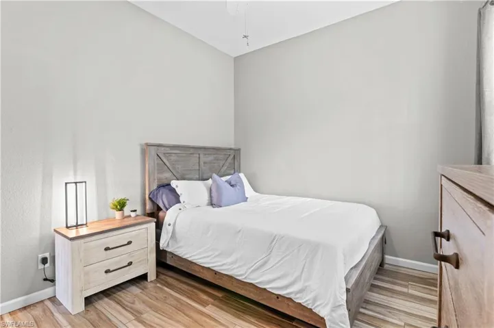 Bedroom with light wood-style floors and ceiling fan