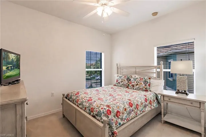 Bedroom featuring ceiling fan and light carpet