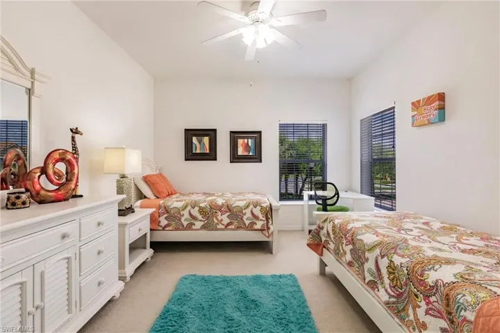 Bedroom featuring light colored carpet and a ceiling fan