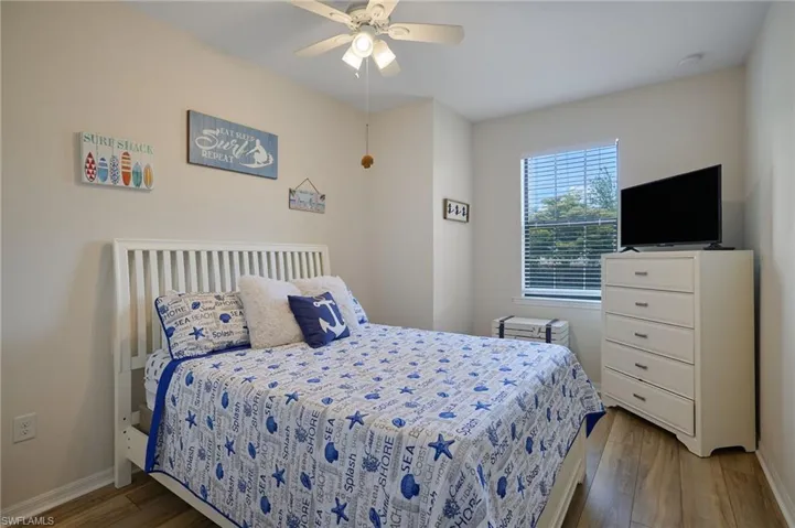 Bedroom featuring a ceiling fan, baseboards, and wood finished floors