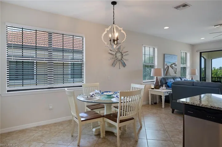 Dining room featuring a chandelier, light tile patterned floors, baseboards, visible vents, and recessed lighting