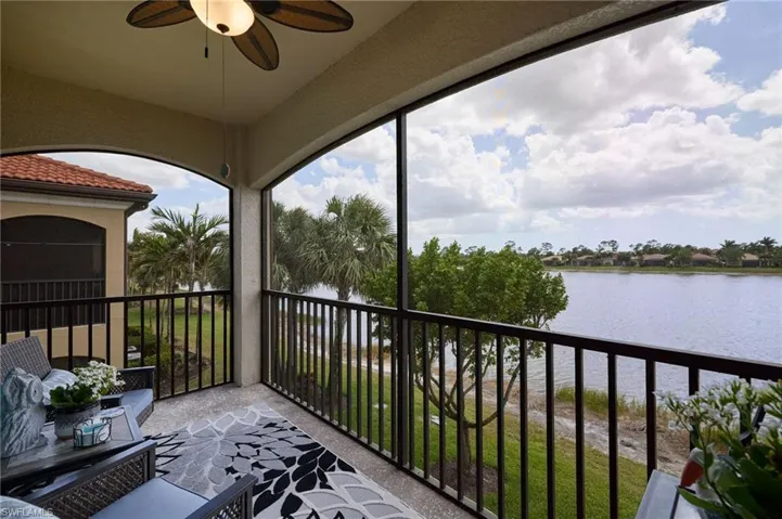 Balcony with a water view and ceiling fan