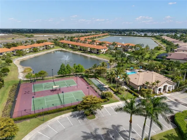 Birds eye view of property with a water view