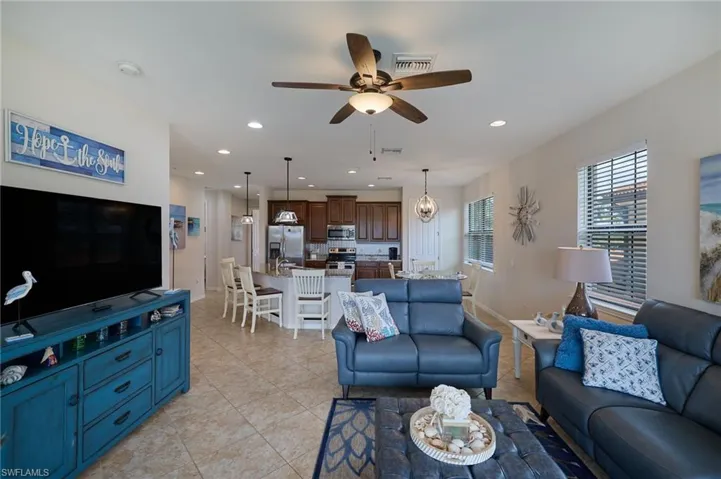 Living room featuring recessed lighting, light tile patterned floors, baseboards, visible vents, and ceiling fan