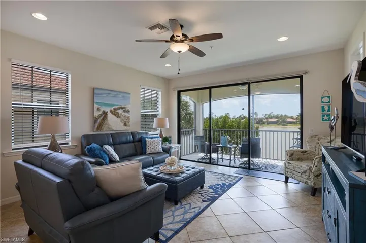 Living room featuring light tile patterned flooring, baseboards, visible vents, ceiling fan, and recessed lighting