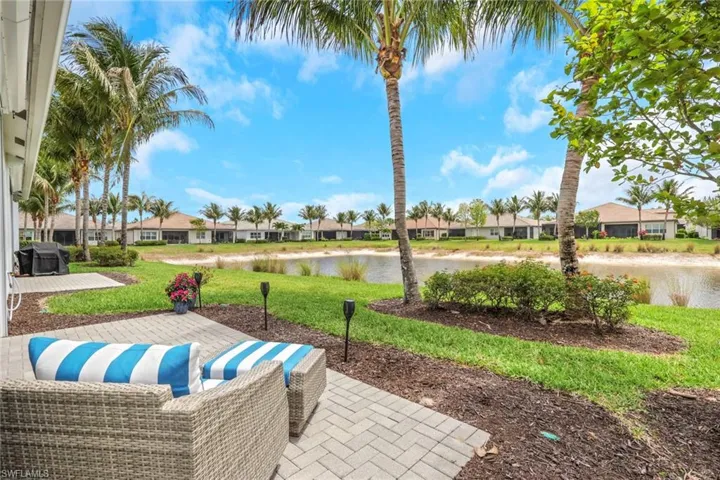 Expansive paver patio offering serene lake frontage