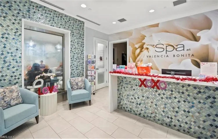 Spa reception area featuring a tiled accent wall and a built-in water feature