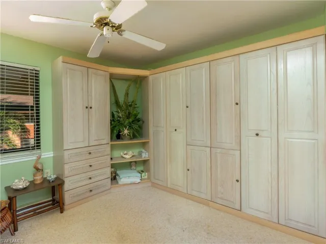Bedroom featuring ceiling fan and two twin murphy beds.
