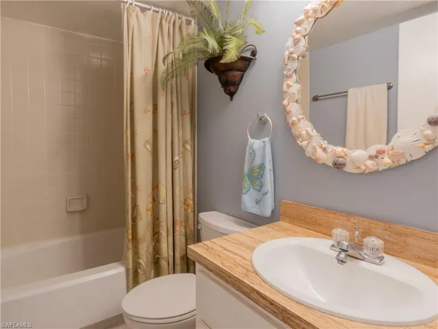 full bathroom featuring a dual tub and shower.