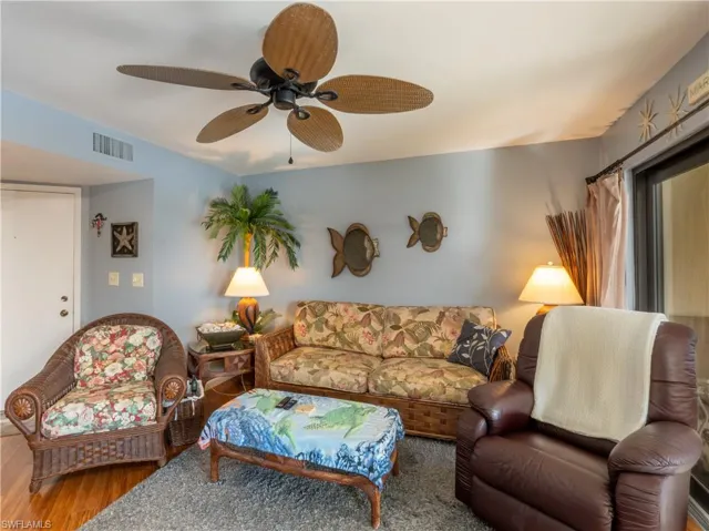 Living room featuring ceiling fan, furniture, and hide-a-bed couch.