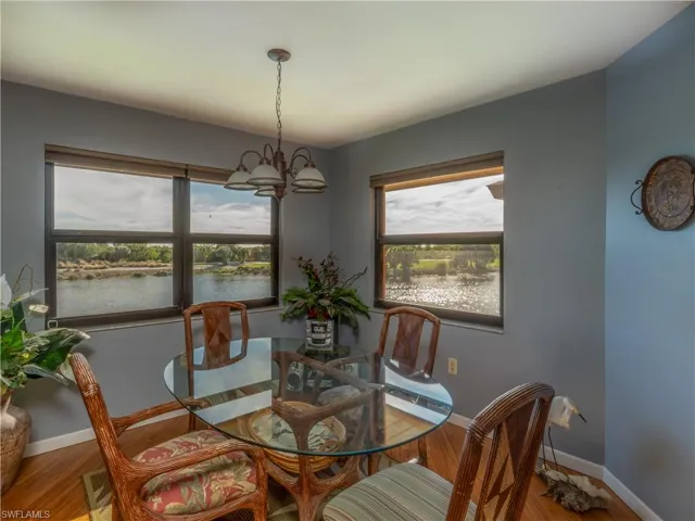 Dining room featuring wooden floors, windows and seating.